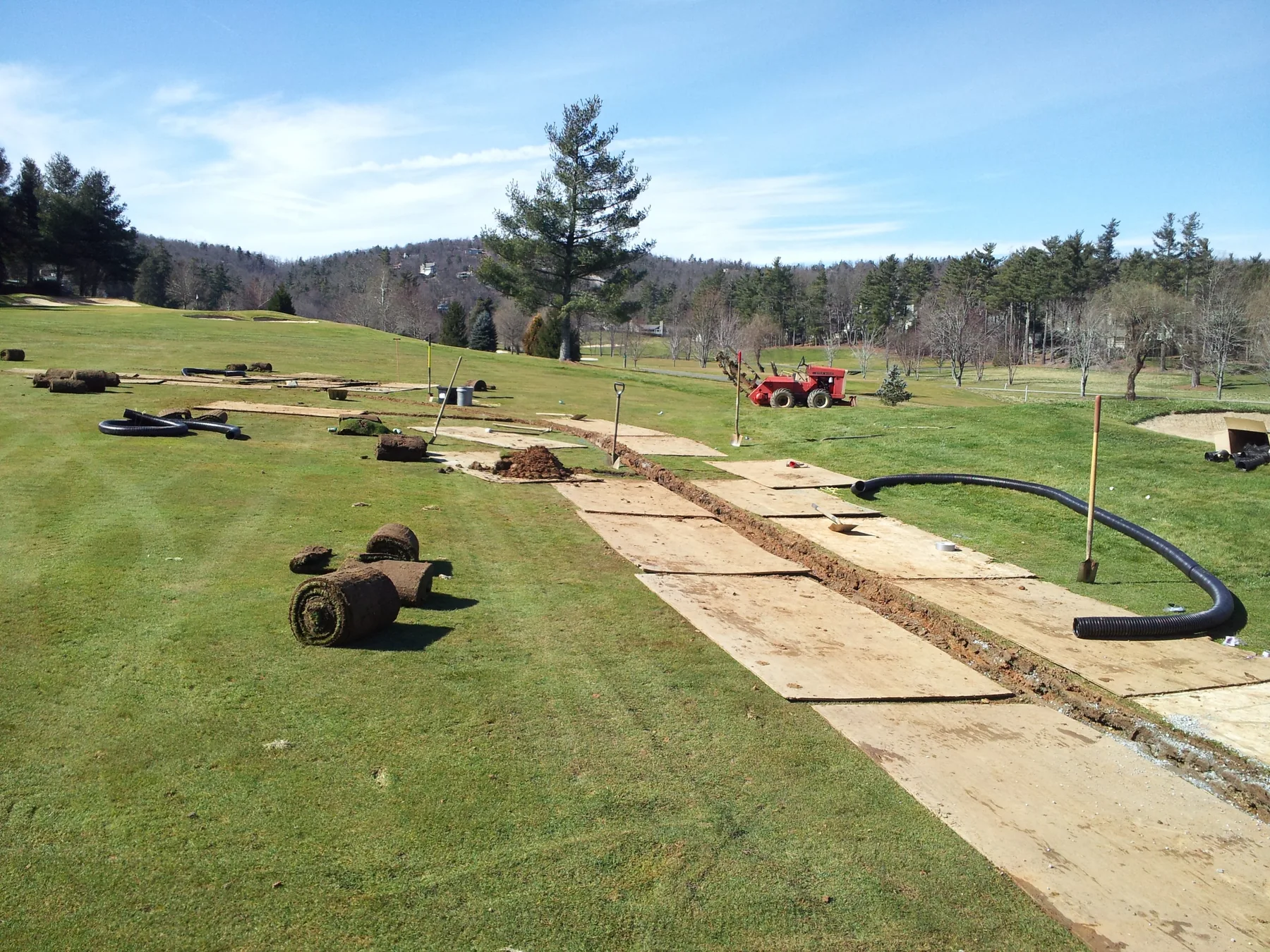 Plywood protected fairway drainage installation