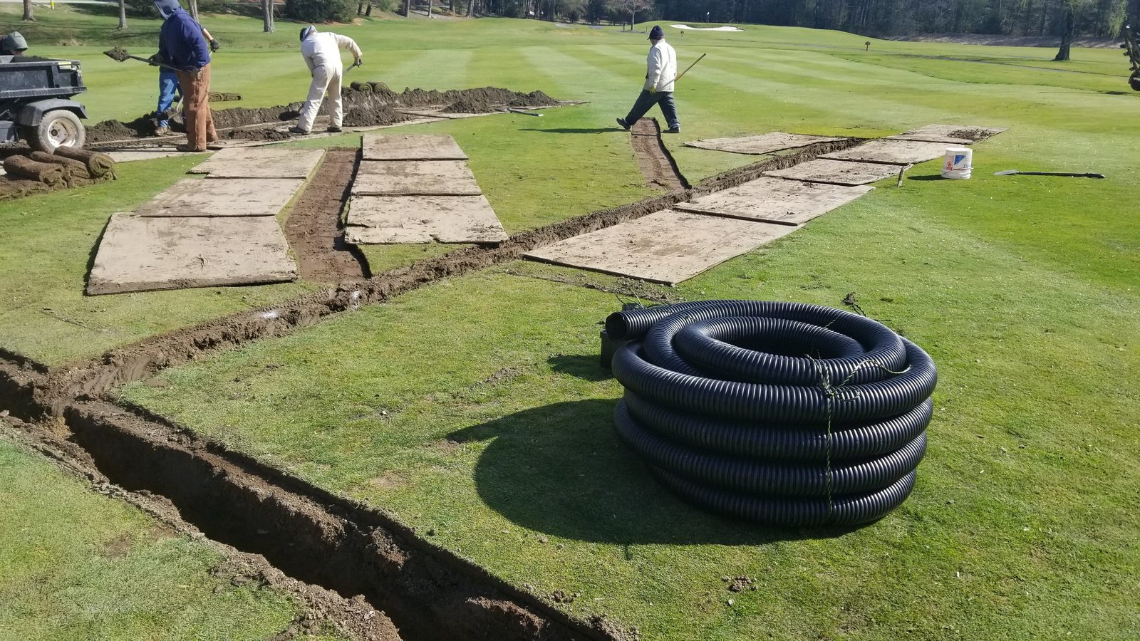 Drainage trenching work on golf course turf